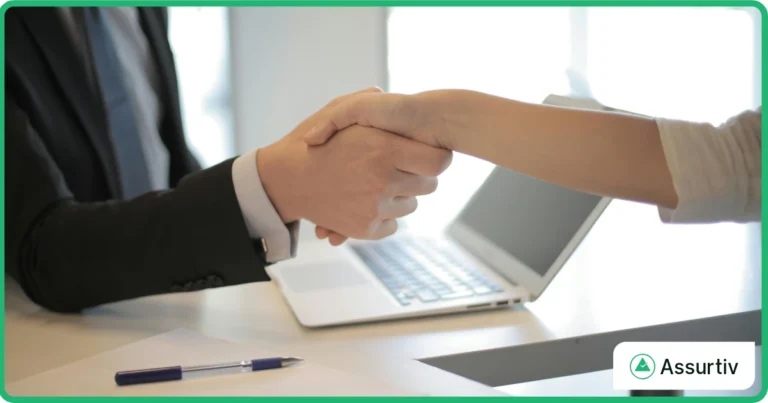 Two employees are handshaking for the success of integrated GRC maturity level