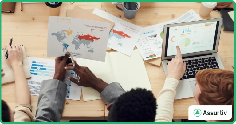employees discussing continuous security controls review framework data on their laptop